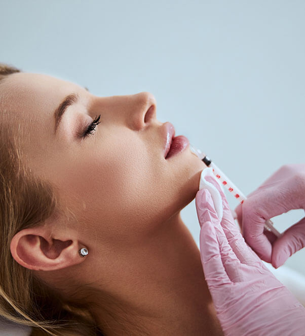 Woman getting lip filler injections
